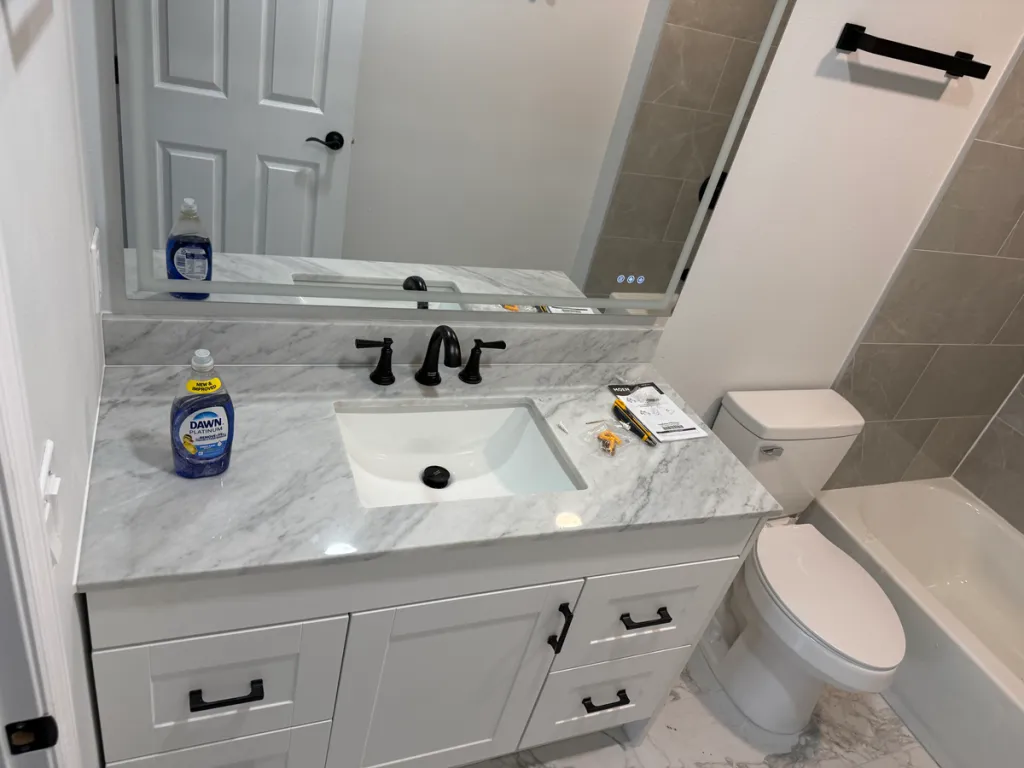 Finished bathroom vanity with a marble countertop