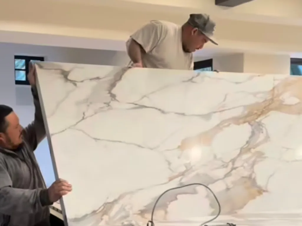 Stone House USA team positioning a large stone slab