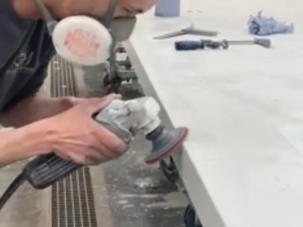 Craftsperson finishing the edge of a countertop